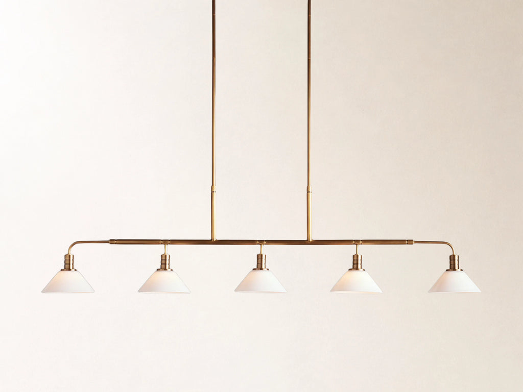 Theron 60" Linear Chandelier with Milk Glass in Brass