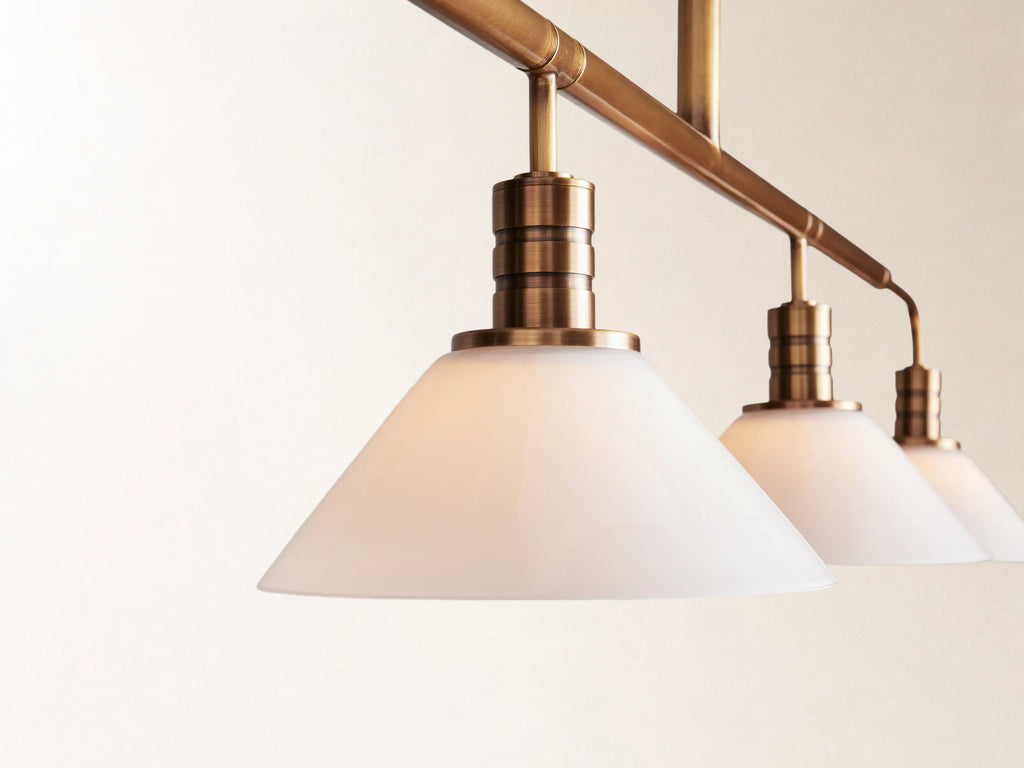 Theron 60" Linear Chandelier with Milk Glass in Brass