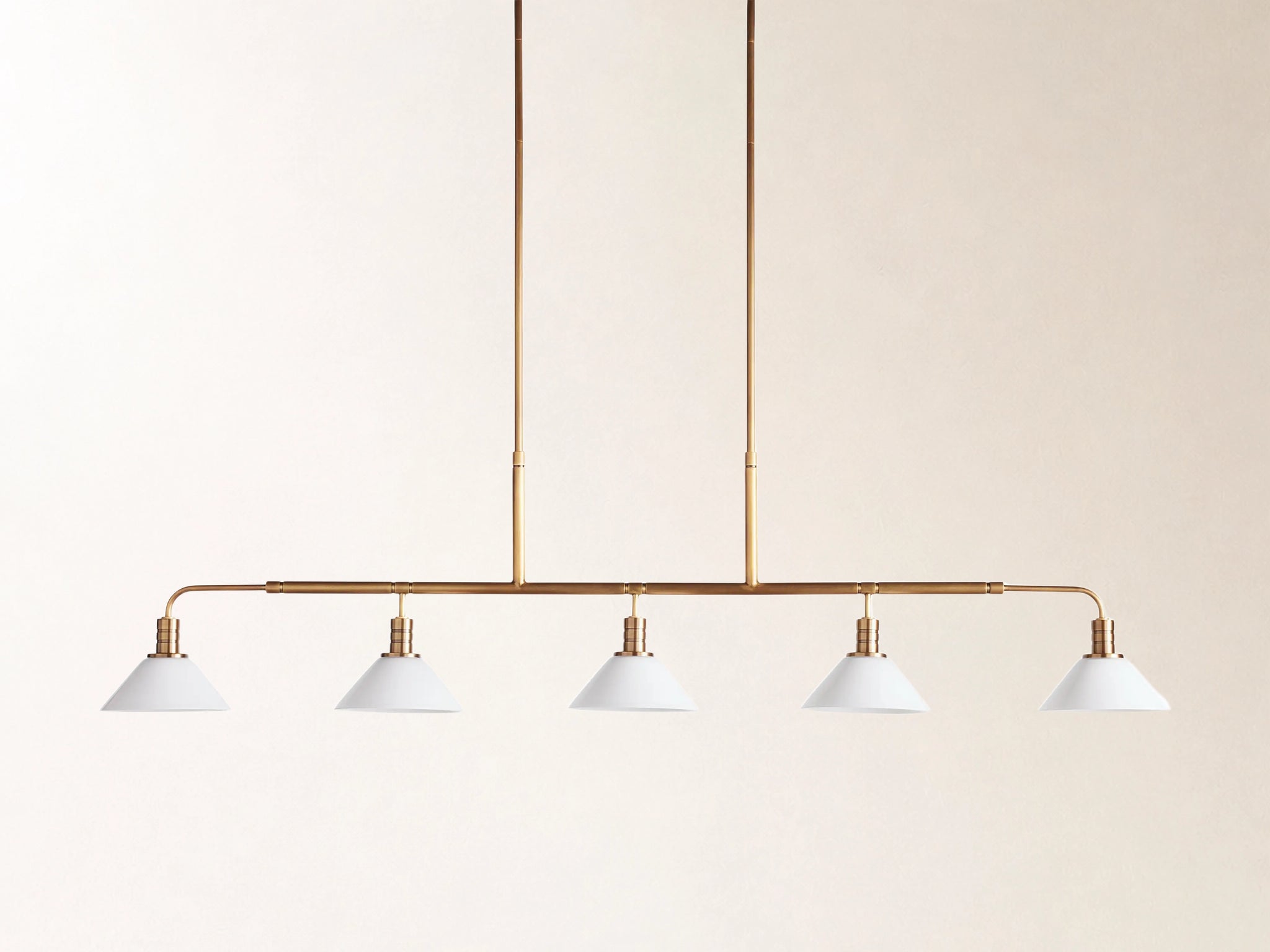 Theron 60" Linear Chandelier with Milk Glass in Brass